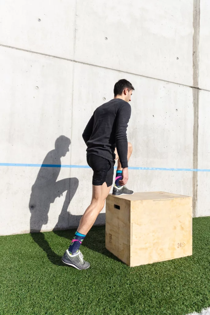 Man training on sports ground near wall